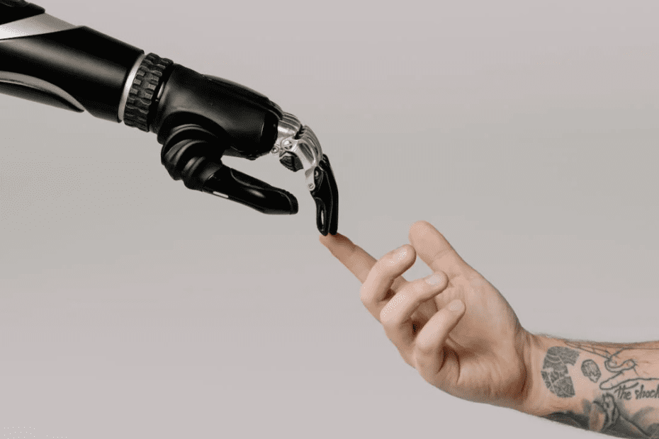 AI in marketing and the impact to work, showing one robotic hand touching a human hand as in michelangelo's painting.